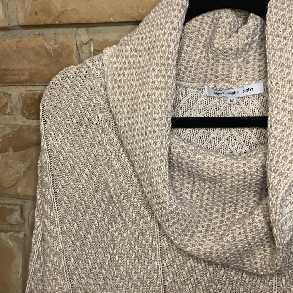 Light tan sweater with exaggerated turtle neck